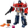 LEGO Optimus Prime 10302 model standing in full robot mode holding an ion blaster alongside its transformation truck display mode