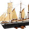 The fully completed LEGO model of The Endurance Ship displayed on its custom brown wood grain stand showing its black hull white upper decks and tan sails