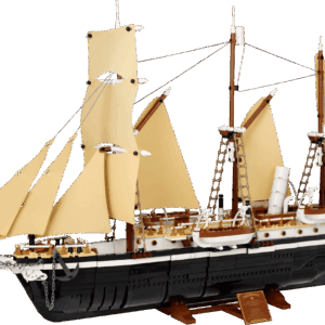 The fully completed LEGO model of The Endurance Ship displayed on its custom brown wood grain stand showing its black hull white upper decks and tan sails