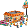A close up view of a molded minifigure representing Krusty the Clown from the Krusty Burger LEGO set collection holding a round pie slice accessory