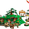 A detailed model of Bag End representing the Shire LEGO Set showing a green circular door round windows a grassy hill roof and an oak tree on top with minifigures arranged in front