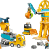 The alternative mobile crane configuration of the Construction LEGO Set showing a long yellow vehicle with a tall extended boom arm lifting a gray structural beam