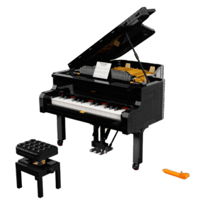 LEGO Grand Piano Ideas model built in polished sleek black with the top lid propped open showing the internal golden strings and a small sheet music stand on the keys