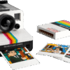 Premium Polaroid Camera Display Case enclosing the retro LEGO camera set on a workspace shelf