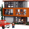LEGO Twilight The Cullen House large scale architectural model showing the three tier modern wood and glass mansion surrounded by green forest trees on a clean presentation backdrop