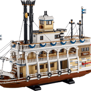 A massive multi deck historic riverboat representing the River Steamboat LEGO set featuring detailed white railings black smokestacks and a large red paddle wheel at the back