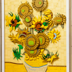 LEGO Vincent van Gogh Sunflowers 3D art set hanging on a wall inside a premium black frame showing detailed gold and yellow textured petals