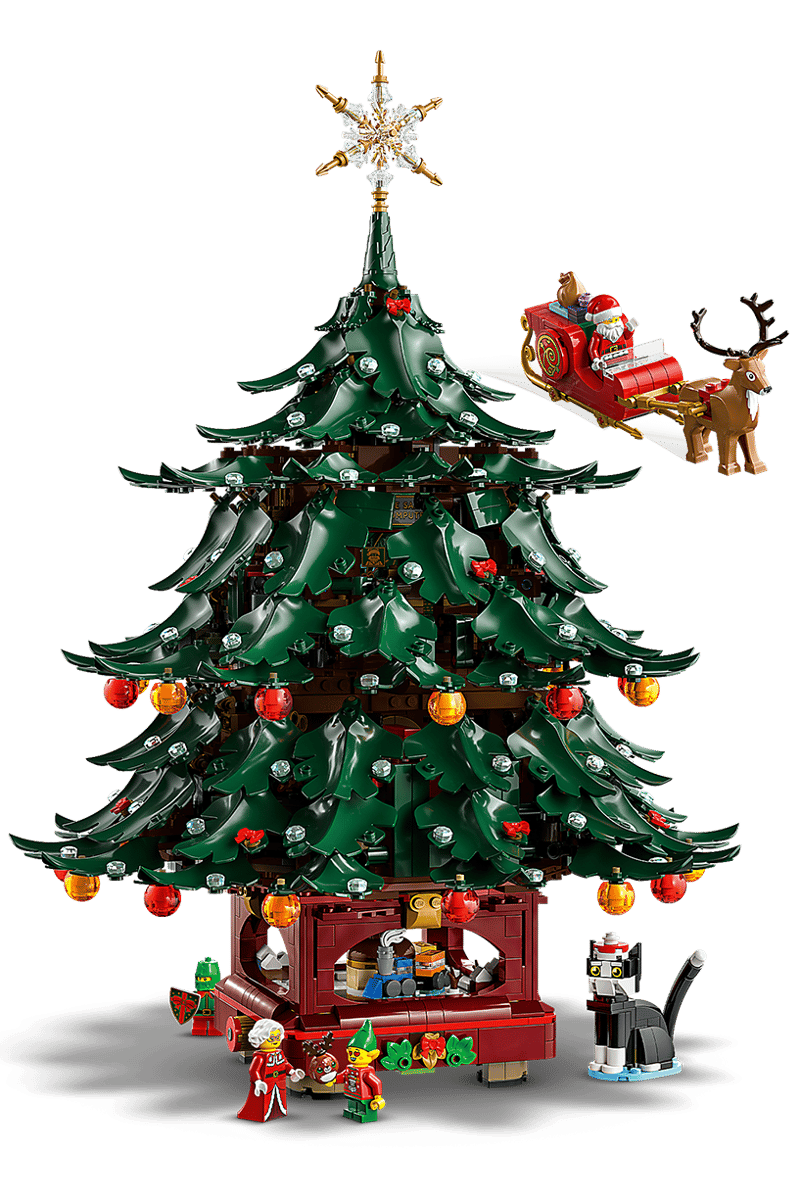 LEGO Family Christmas Tree seasonal display set 40573 built as two distinct decorated holiday trees on a wooden tabletop surface