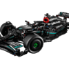 LEGO Mercedes-AMG F1 W14 E Performance model built in a stealth matte black racing livery with petronas green stripes displayed on a clean showroom floor