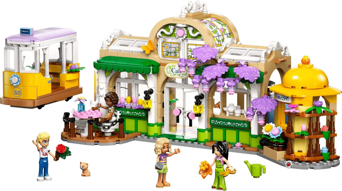 The built Plant Cafe and Flower Shop LEGO set showing a tan and green building with purple wisteria flowers a yellow tram car out front and several minidolls tending the gardens