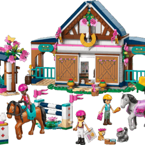 The official retail packaging box showing the completed Horse Stable LEGO forest riding center building with textured wood siding blue roofs a gray horse and a tan horse being ridden by mini dolls near a campfire