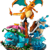 The fully assembled LEGO Pokemon Starters diorama set showcasing the brick built Venusaur in a green jungle Charizard over a red lava volcano and Blastoise standing on a sandy beach base