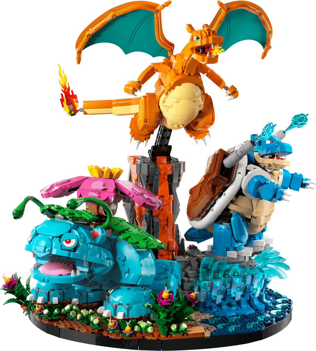 The fully assembled LEGO Pokemon Starters diorama set showcasing the brick built Venusaur in a green jungle Charizard over a red lava volcano and Blastoise standing on a sandy beach base
