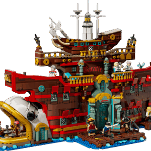 LEGO Baratie Ship One Piece anime exhibition model showing the large brown wooden restaurant hull with a white fish head prow alongside character minifigures on a blue ocean base