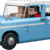 The built light blue Anglia Harry LEGO car with a white roof standing next to Harry Potter and Ron Weasley minifigures a brown suitcase Hedwig the owl and Scabbers the rat