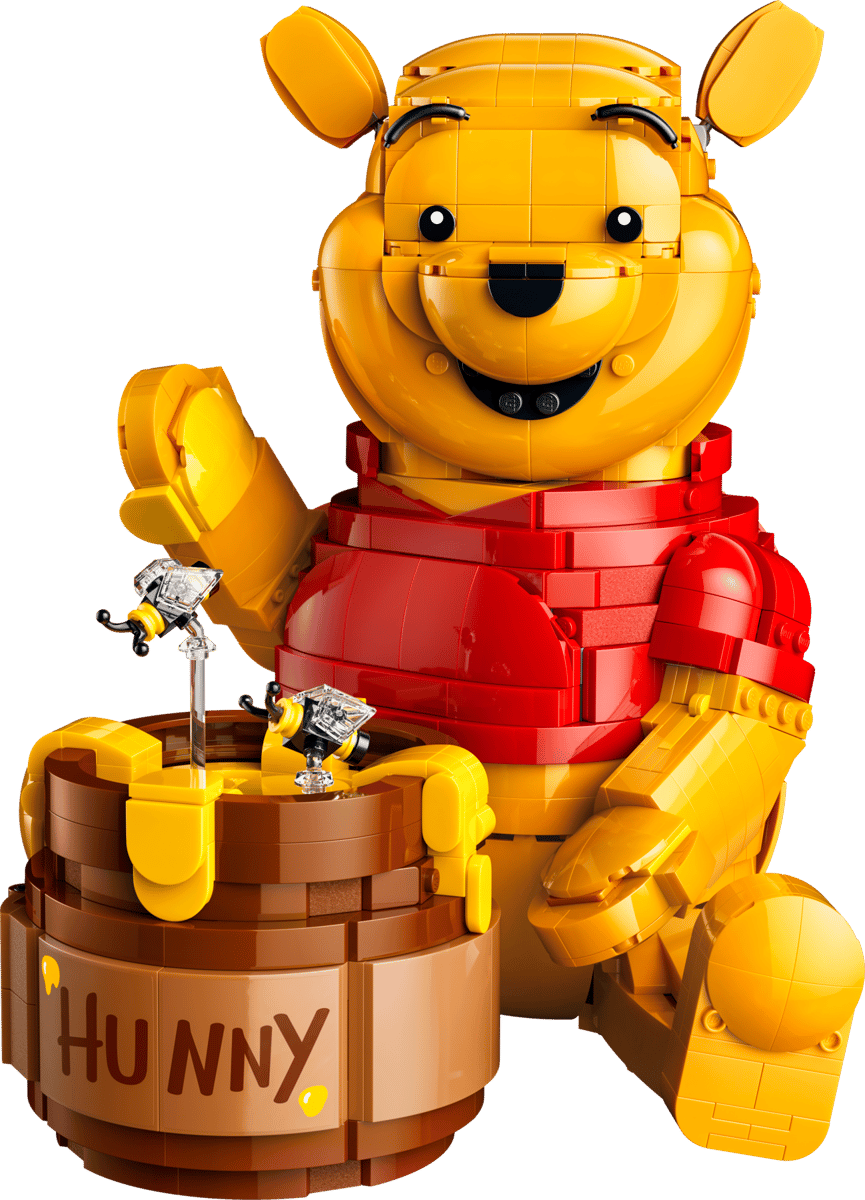 LEGO Winnie Pooh storybook display model featuring Pooh's brick built oak tree house with green foliage and beehives surrounded by character minifigures like Piglet and Eeyore