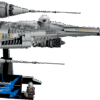 LEGO Mandalorian's N-1 Starfighter UCS master scale model built with metallic silver and grey hull panels floating diagonally on a sleek black display stand with an information plaque