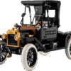 LEGO Ford Model T vintage car model built in classic black with brass colored headlights and spoked wheels displayed on a wooden table